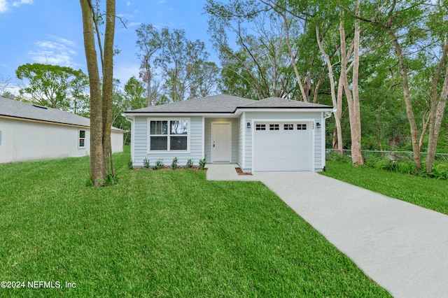 view of front of property with a garage and a front yard