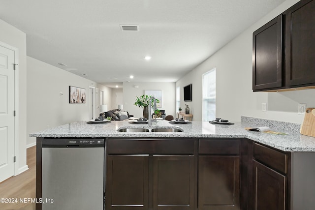 kitchen with kitchen peninsula, light wood-type flooring, dark brown cabinetry, sink, and dishwasher