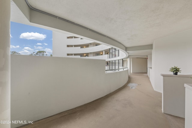 corridor featuring a textured ceiling