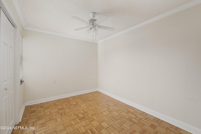 empty room featuring a textured ceiling, light parquet floors, ceiling fan, and crown molding