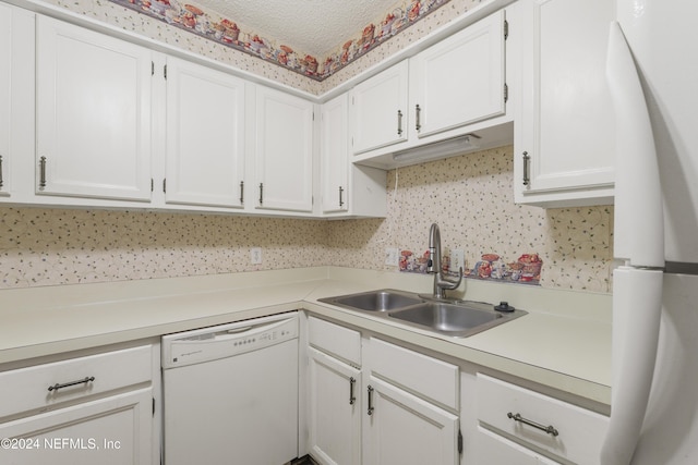 kitchen with white cabinets, white appliances, and sink