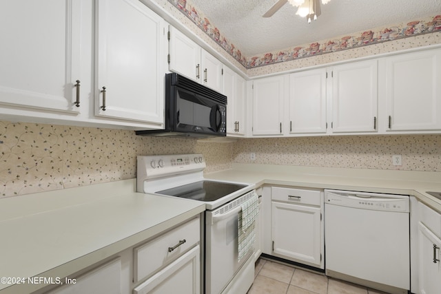 kitchen featuring light tile patterned floors, white appliances, a textured ceiling, and white cabinetry