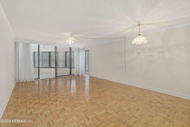 spare room with light parquet floors, ceiling fan with notable chandelier, a textured ceiling, and ornamental molding