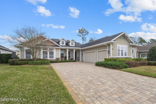 view of front of home with a front yard and a garage