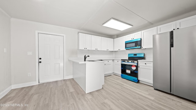 kitchen featuring stainless steel refrigerator, backsplash, light hardwood / wood-style floors, white cabinets, and range