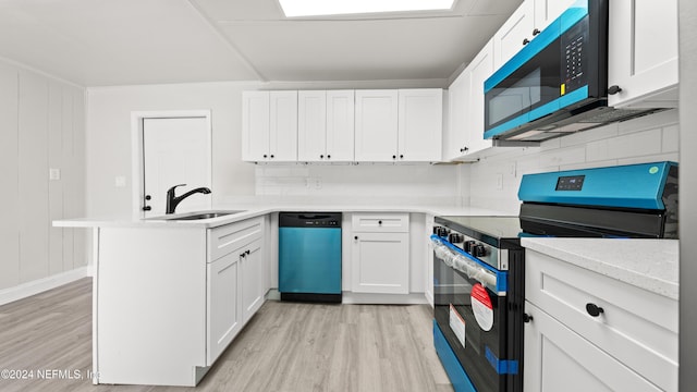 kitchen with dishwasher, range with electric cooktop, white cabinetry, and sink