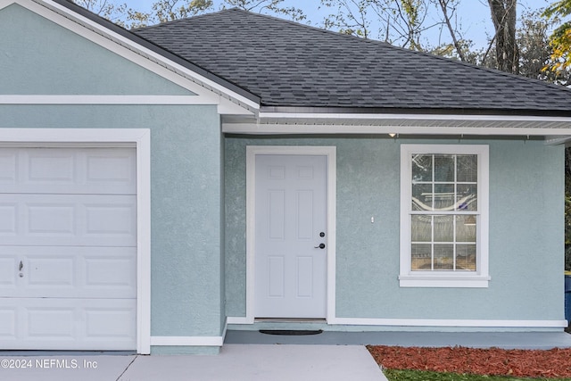 doorway to property featuring a garage