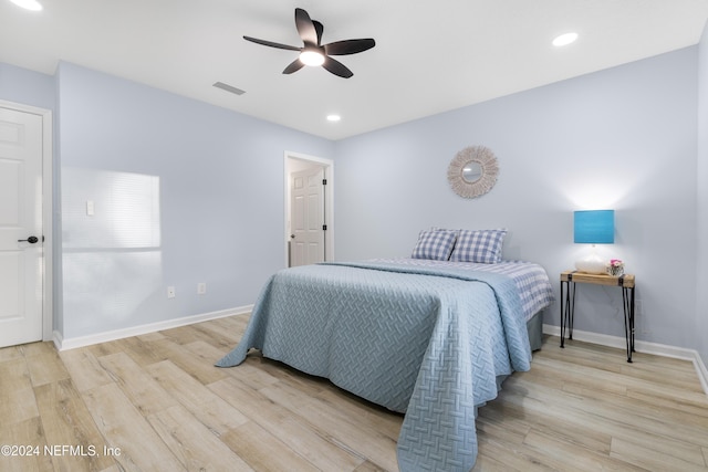 bedroom with light hardwood / wood-style floors and ceiling fan