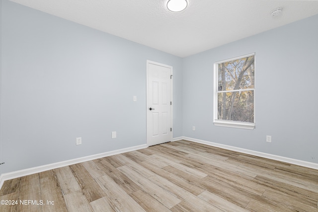 spare room with light wood-type flooring