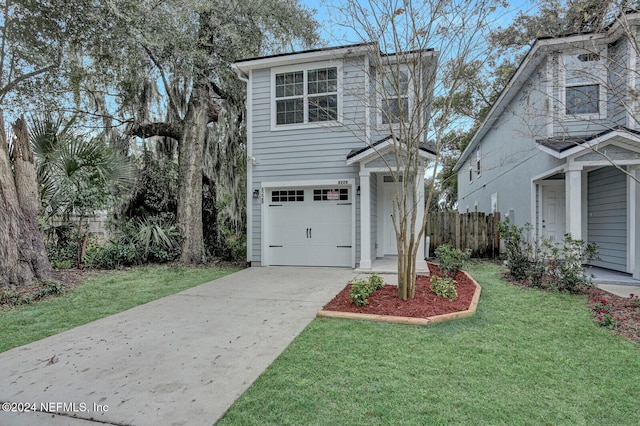 view of front facade with a garage and a front lawn