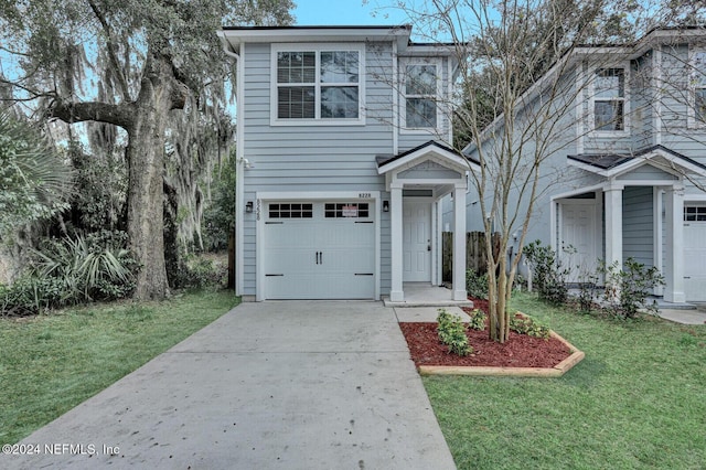 view of front of home featuring a garage and a front yard