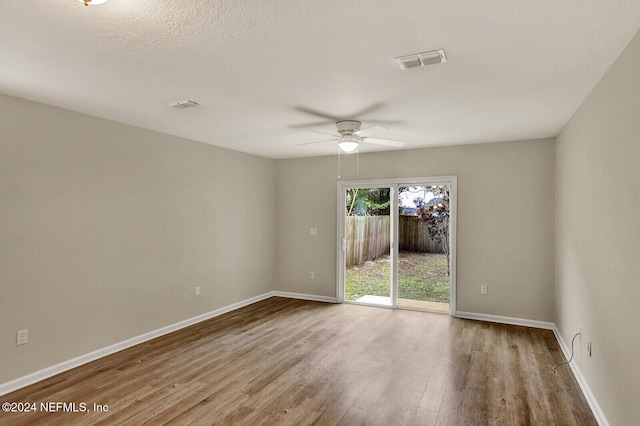 empty room featuring ceiling fan and light wood-type flooring