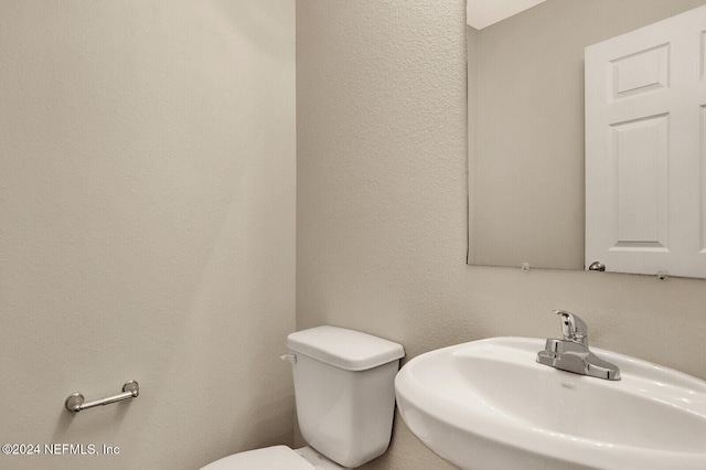 bathroom featuring sink and toilet