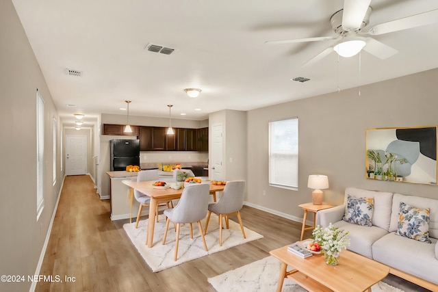 interior space with ceiling fan and light hardwood / wood-style flooring