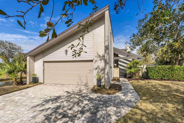 view of home's exterior with a garage and a yard