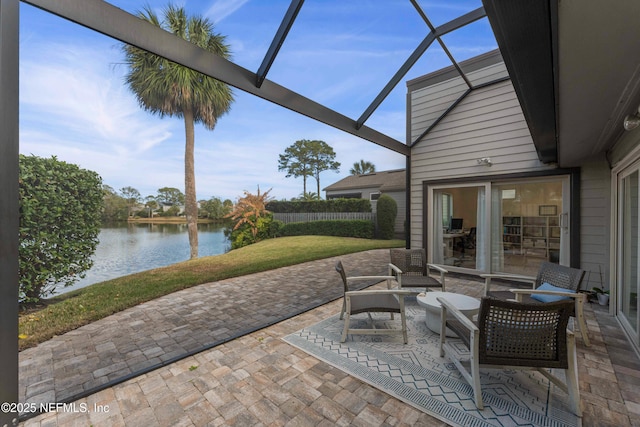 view of patio / terrace with a water view, an outdoor living space, and glass enclosure