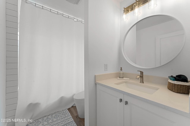 full bathroom with hardwood / wood-style flooring, vanity, toilet, and shower / tub combo