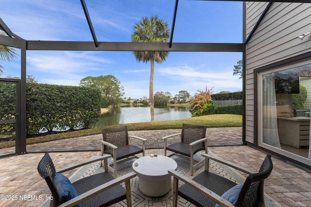 sunroom featuring a water view and a healthy amount of sunlight