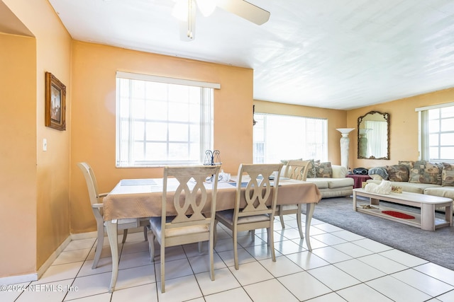 dining area featuring a wealth of natural light, light tile patterned flooring, and ceiling fan