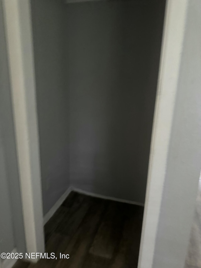 empty room with dark hardwood / wood-style flooring