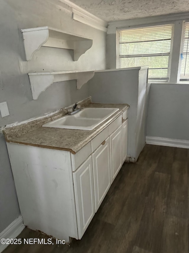 kitchen featuring sink, white cabinets, and dark hardwood / wood-style flooring