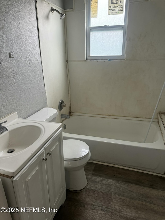 full bathroom with toilet, vanity, wood-type flooring, and shower / tub combination