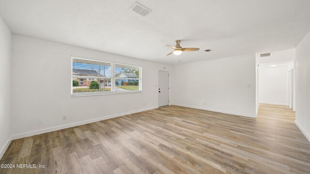 spare room with light hardwood / wood-style flooring and ceiling fan