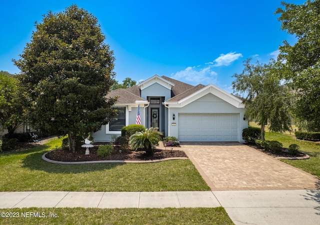 view of front of property with a garage and a front lawn