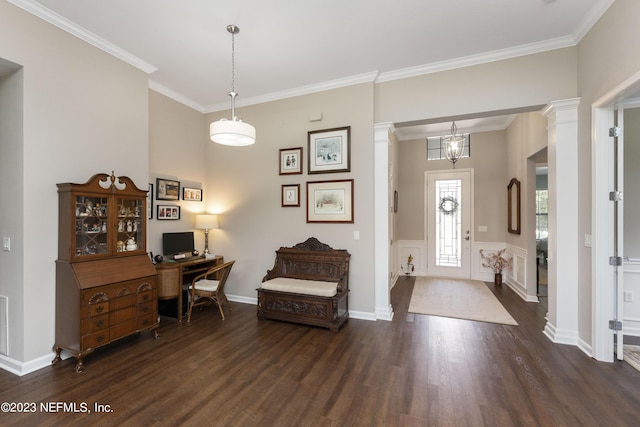 foyer entrance with dark hardwood / wood-style flooring, decorative columns, an inviting chandelier, and crown molding