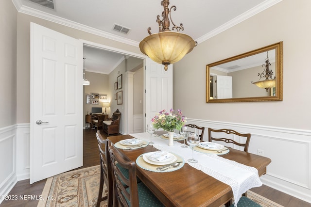 dining room featuring dark hardwood / wood-style flooring and crown molding