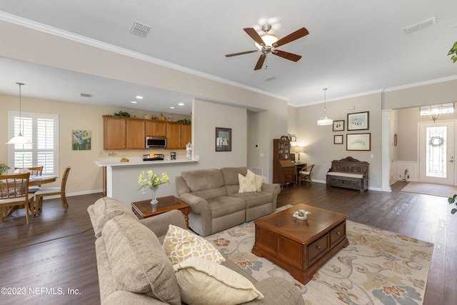 living room featuring a wealth of natural light, ceiling fan, hardwood / wood-style floors, and ornamental molding