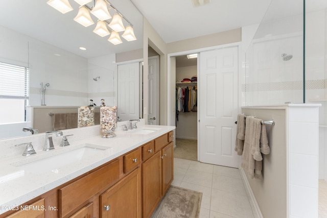 bathroom featuring tile patterned floors, vanity, and tiled shower