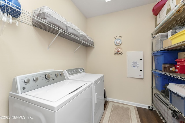 laundry room with independent washer and dryer and hardwood / wood-style flooring