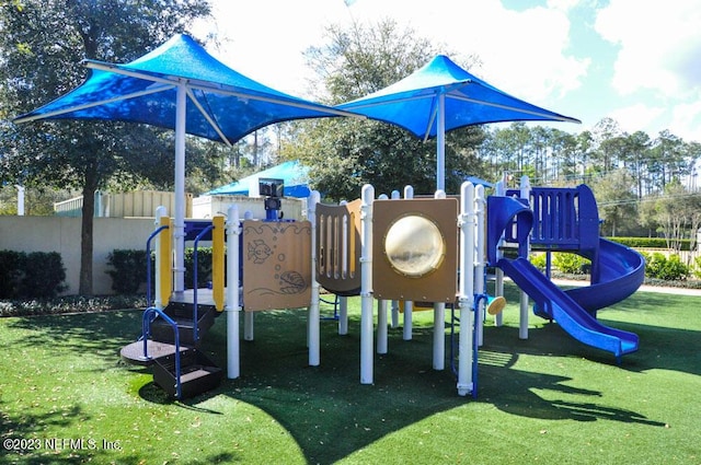 view of playground with a lawn