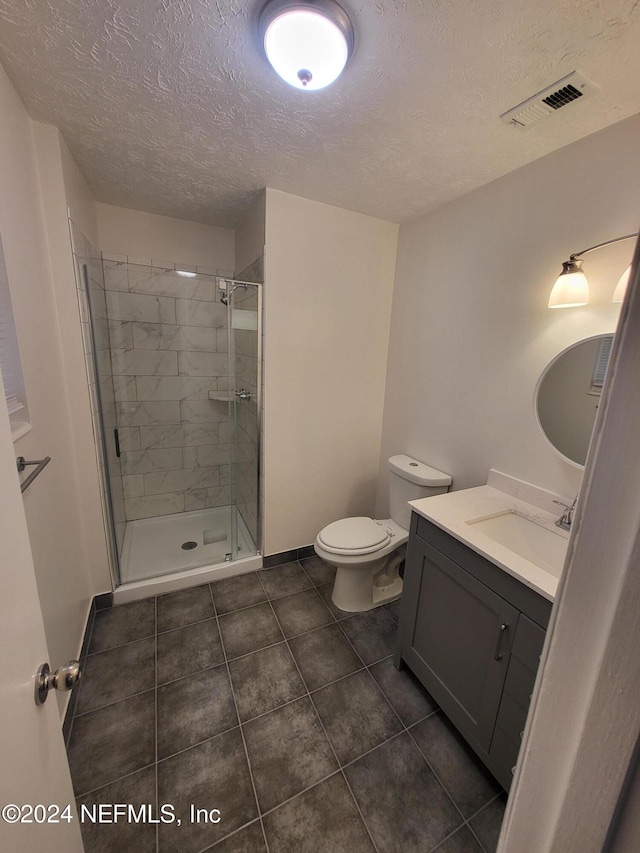 bathroom with vanity, a shower with shower door, and toilet