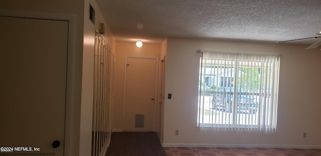 entryway with ceiling fan and a textured ceiling