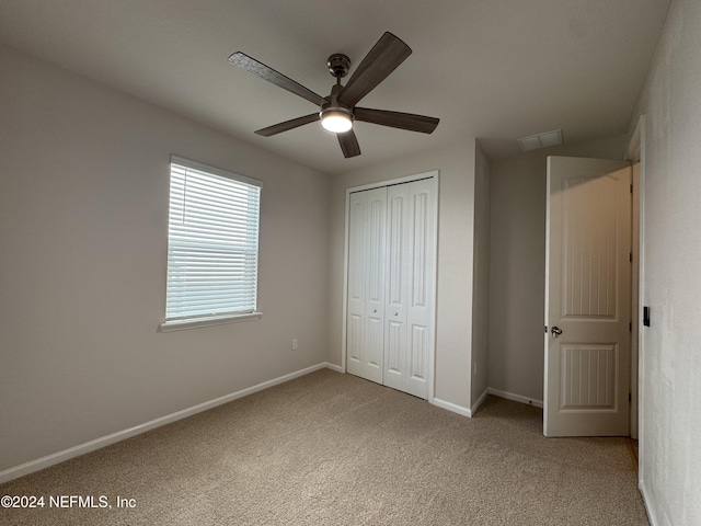 unfurnished bedroom with a closet, ceiling fan, and carpet