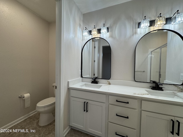 bathroom with tile patterned floors, an enclosed shower, vanity, and toilet