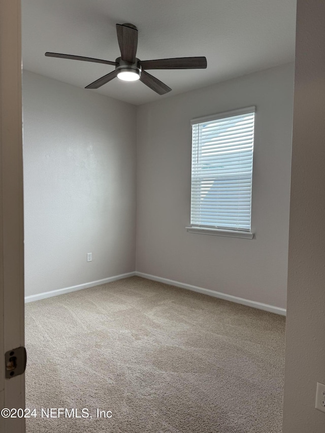 carpeted empty room featuring ceiling fan