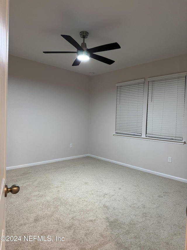 carpeted empty room with ceiling fan