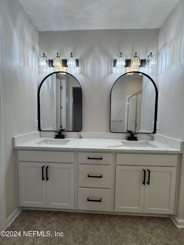 bathroom with walk in shower and vanity