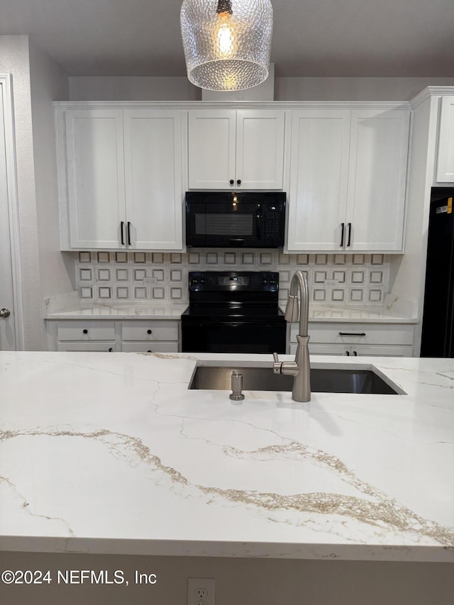 kitchen with black appliances, light stone countertops, decorative backsplash, white cabinets, and sink