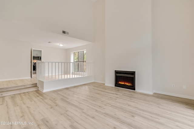 unfurnished living room with light wood-type flooring