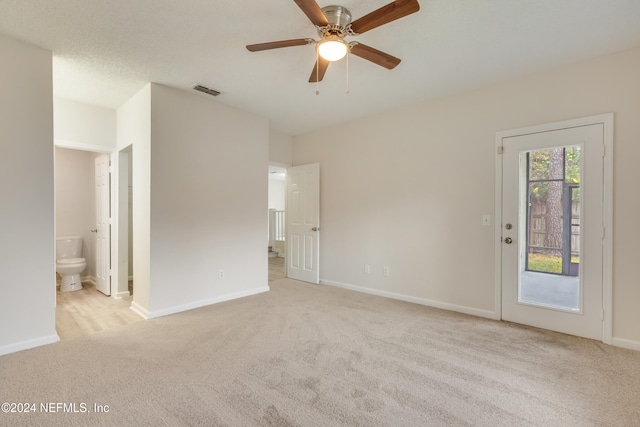 unfurnished room with ceiling fan and light colored carpet