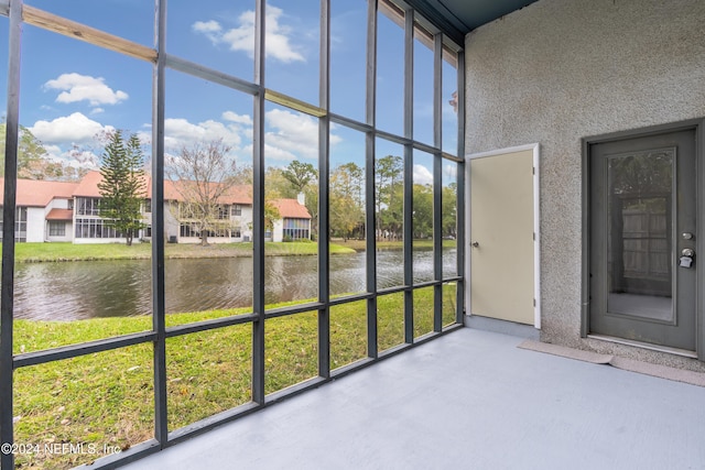 unfurnished sunroom with a water view