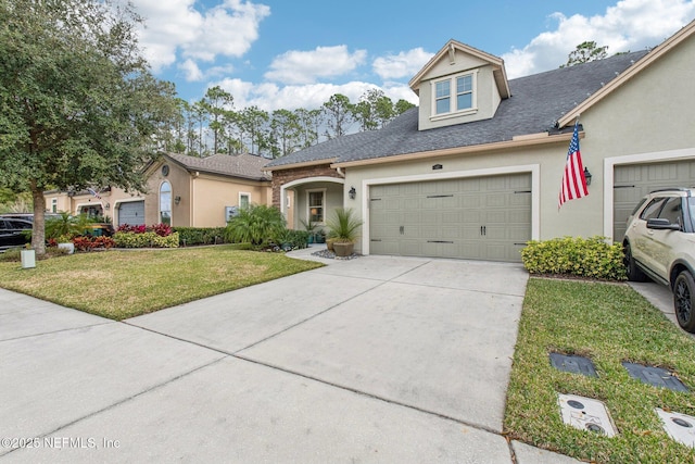 view of front of house featuring a garage and a front lawn