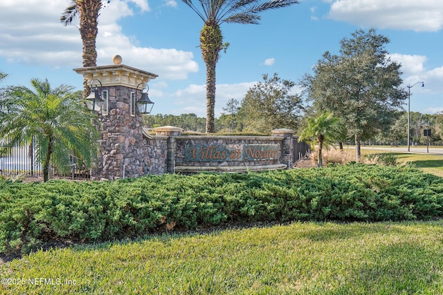 community / neighborhood sign with a lawn