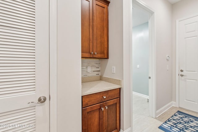 interior space with tasteful backsplash and light tile patterned flooring