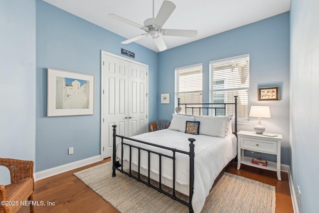 bedroom with dark hardwood / wood-style flooring, a closet, and ceiling fan