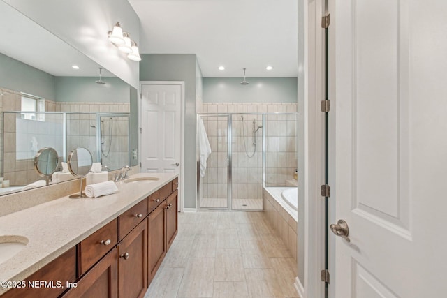 bathroom featuring vanity and shower with separate bathtub